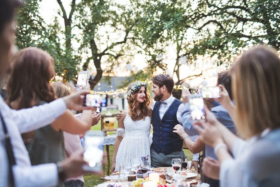 Wedding guests celebrating the couple outdoors